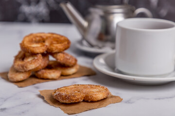 tea with milk and Palmiers cookies on marble
