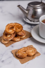 tea with milk and Palmiers cookies on marble