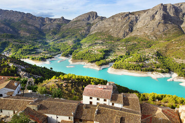 Naklejka premium A stunning lake in Spain with a gentle blue water hid between mountains with small towns.