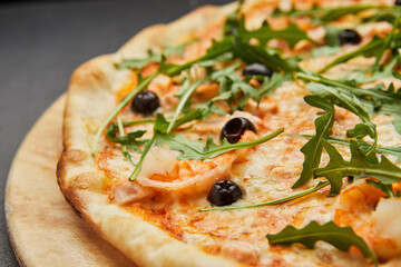 Delicious Italian seafood pizza on dark background