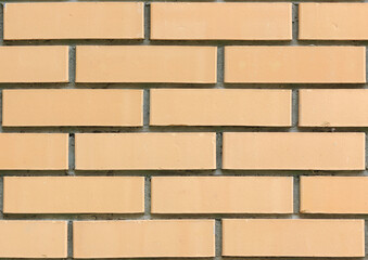 Light yellow brick wall of building close-up view