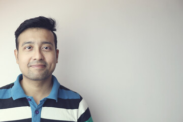 a young indian man confident and smiling isolated in white background with copy space for text