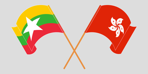 Crossed and waving flags of Myanmar and Hong Kong