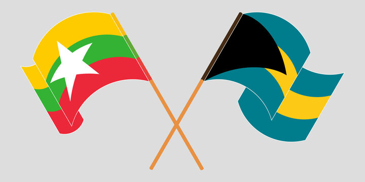 Crossed and waving flags of Myanmar and Bahamas