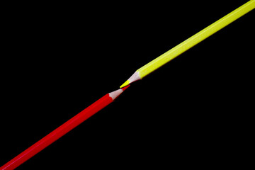 red and yellow pencils are beautifully designed on a dark black background, a great picture of a combination of red and yellow colors