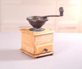 Old obsolete manual coffee grinder made of wood and iron