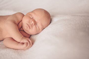 Cute emotional newborn funny little baby boy sleeping in crib. Baby goods packaging template. Healthy child, concept of hospital and happy motherhood. Infant baby. Nursery