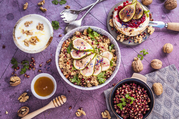 top view of gourmet dish with Figs fruits, nuts, honey, couscous and pomegranate seeds on table