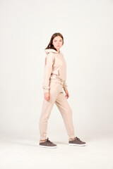Fashion model dressed in casual beige suit posing in the studio for Look book 