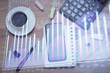 Multi exposure of forex graph hologram over desktop with phone. Top view. Mobile trade platform...