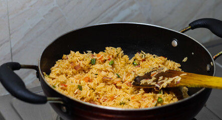 fried rice pulao cooking in a frying pan