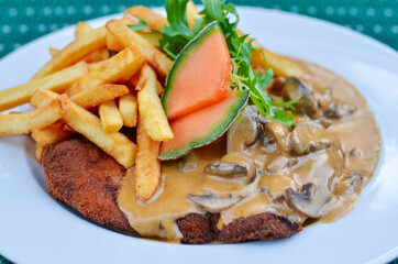 Beef steak with fries, melon and mushrooms. Selective focus.