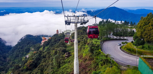 cable car at genting highlands, malaysia in a foggy weather with green grass visible from inside...