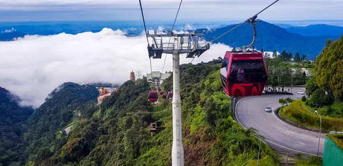 Deurstickers Huangshan cable car at genting highlands, malaysia in a foggy weather with green grass visible from inside cable car