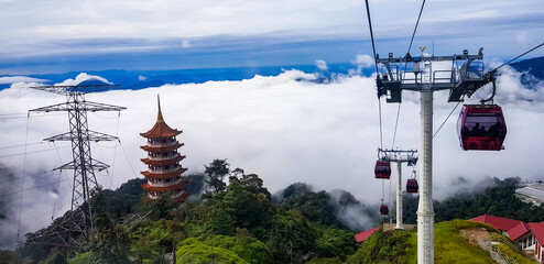 cable car at genting highlands, malaysia in a foggy weather with chin swe chinese temple visible...