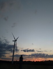 Wind turbine at sunset - 378443195