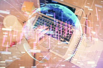 Double exposure of man's hands typing over computer keyboard and forex graph hologram drawing. Top view. Financial markets concept.