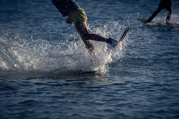 Fototapeta premium WAKEBOARDING AT THE SEA LANDING FROM A JUMP. CONCEPT OF EXTREME SPORTS IN WATER