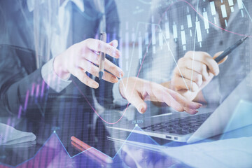 Multi exposure of man and woman working together and financial chart hologram. Business concept. Computer background.