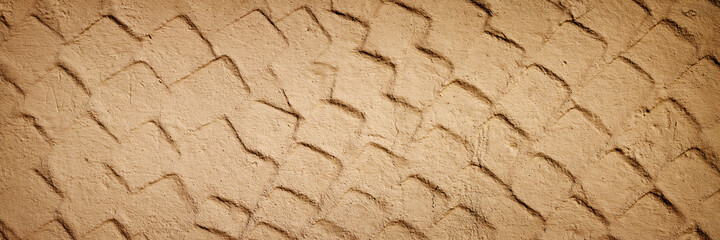 The texture of the plastered wall. Rough corrugated cement surface. Uneven angular pattern. Panoramic background for grunge design.