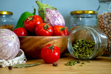 Zero waste healthy food-cereals, seeds, vegetables flat lay on grey background. Groceries in textile bags,glass jars, wooden bowl. Eco friendly plastic free low waste lifestyle.