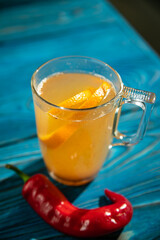 Fruit tea in a transparent cup. In the coffee shop
