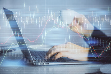 Double exposure of businesswoman hands typing on computer and forex graph hologram drawing. Financial analysis concept.