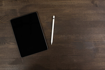 Tablet and electronic pen on the table.