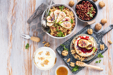 top view of gourmet dish with Figs fruits, nuts, honey, couscous and pomegranate seeds on table