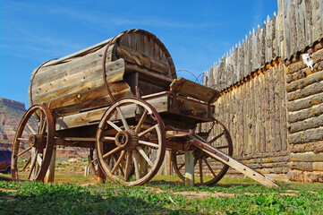 Fototapeta na wymiar Vintage Wooden Water Wagon outside a wooden stockade