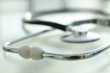 Black stethoscope on glass table