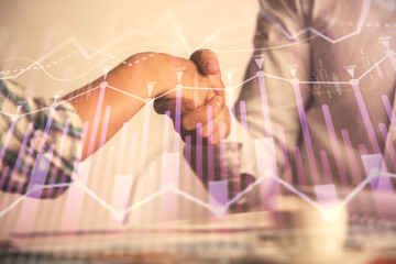 Double exposure of forex graph hologram and handshake of two men. Stock market concept.