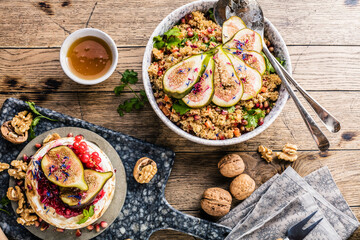 top view of gourmet dish with Figs fruits, nuts, honey, couscous and pomegranate seeds on table