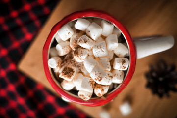 Cup of coffee with marshmallows on red background 
