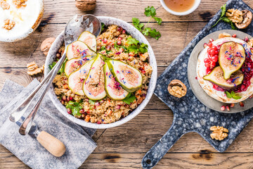 top view of gourmet dish with Figs fruits, nuts, honey, couscous and pomegranate seeds on table