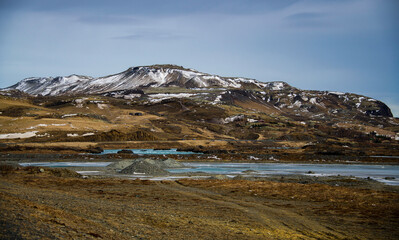 Mountain peak in a colorful Icelandic landscape with snow and water