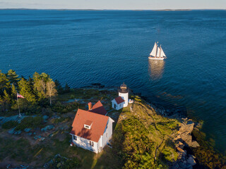 Aerial Drone image of the Curtis Island Lighthouse att he entrance to Camden Harbor on Penobscot...