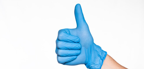 Hand in Medical Blue Latex Glove Giving Thumbs Up Sign. Like. White background. Protection concept