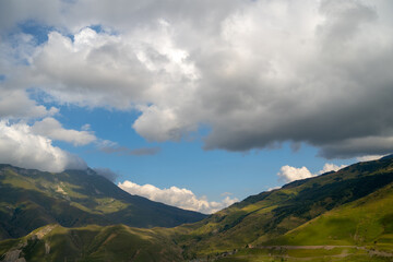 Obraz premium Mountain peaks against cloudy sky. Peaks of magnificent rocks located against bright cloudy sky