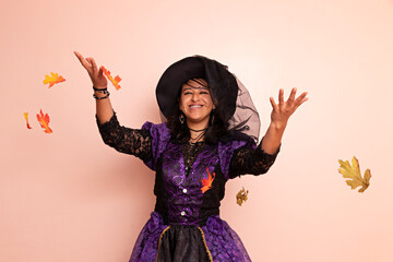 A woman dressed in a witch costume posing