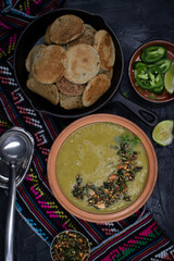 Vegan green peas and buckwheat plinis on dark backround