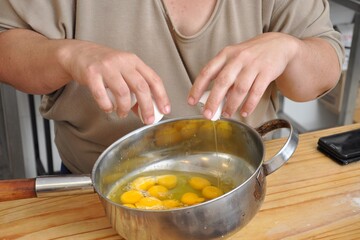 Person breaking eggs