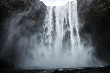 Powerful waterfall in Iceland with mist