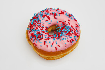 Delicious pink doughnut with red and blue chocolate chips