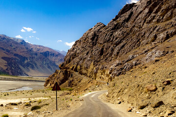 curved hilly highway in between barren himalayan mountains of leh ladakh, jammu and kashmir, India