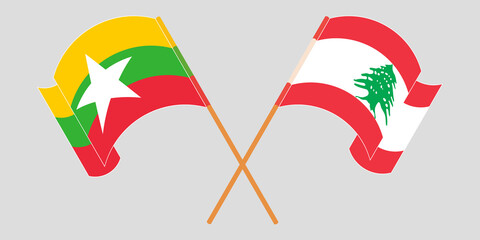 Crossed and waving flags of Myanmar and Lebanon