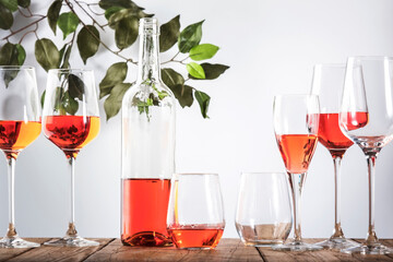 Rose wine glass with bottle on the white table. Rosado, rosato or blush wine tasting in wineshop, bar concept. Copy Space