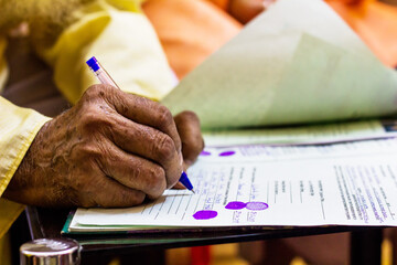 hand of an old man writing important legal document