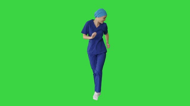 Girl doctor is dancing and walking on a Green Screen, Chroma Key.