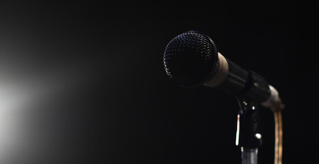 singing mic on a black background with space for text
